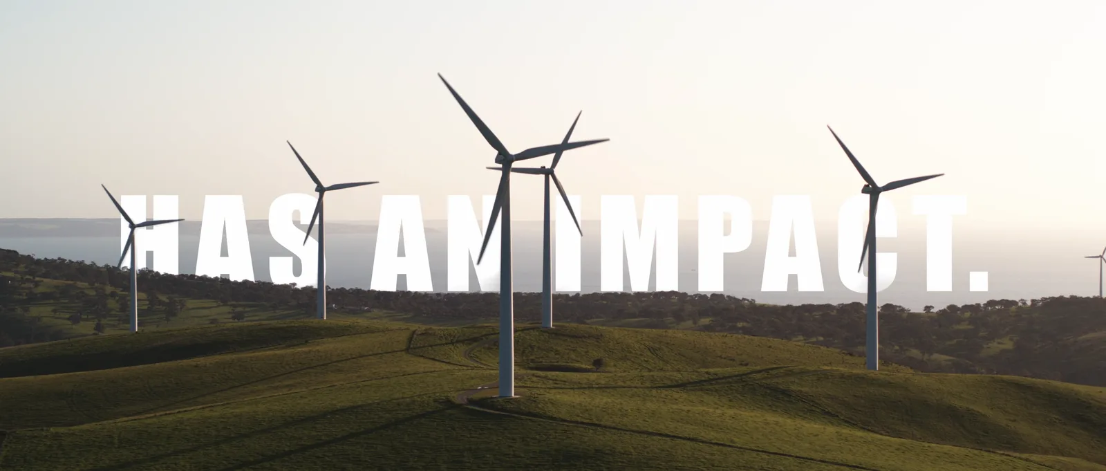 Wind turbines on green hills behind title text