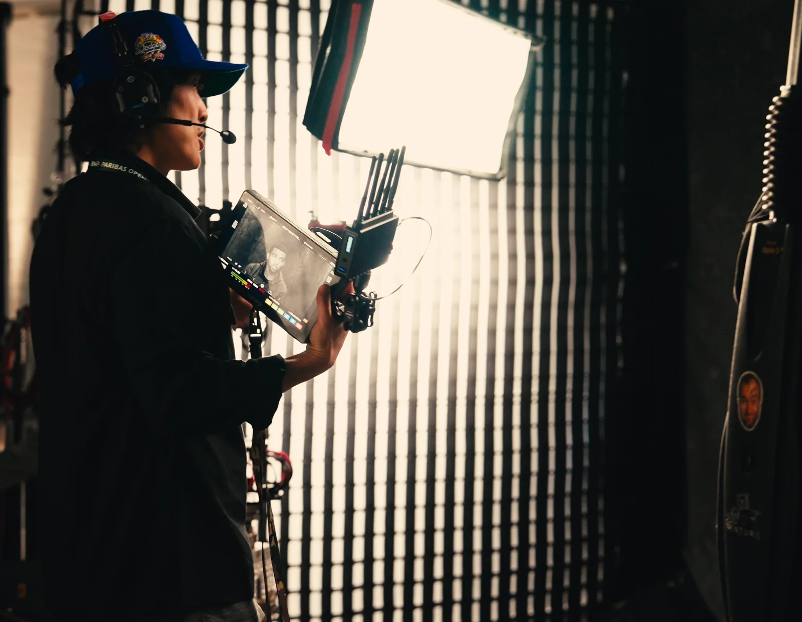 Camera operator behind the scenes with a studio light