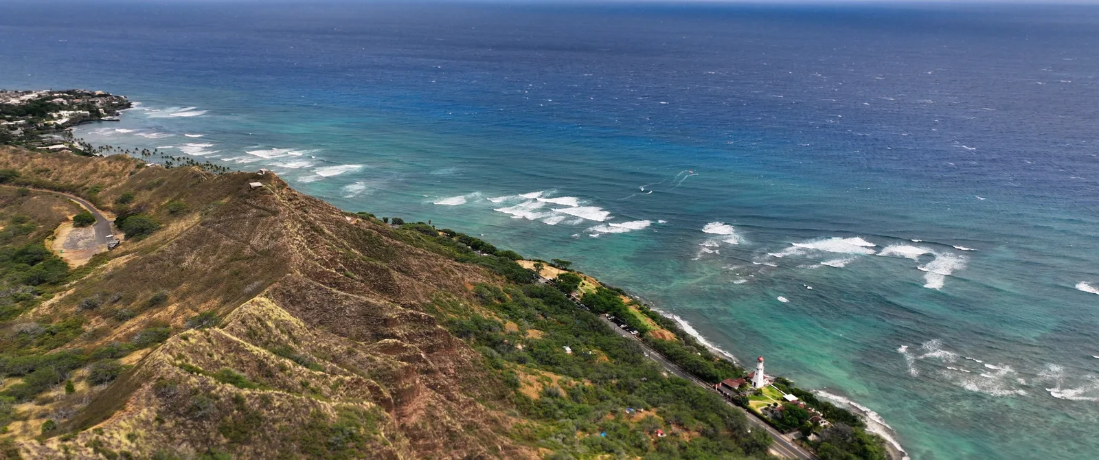 Aerial of the Diamond Head coastline with turquoise surf